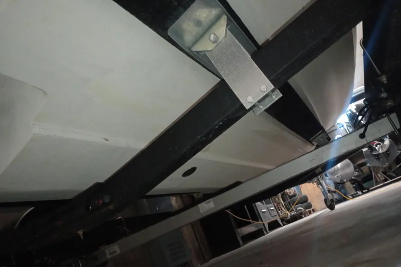 Slide: The Image of Underside view of 2022 Bayliner VR5 Bowrider I/O on a trailer in a garage. - 28