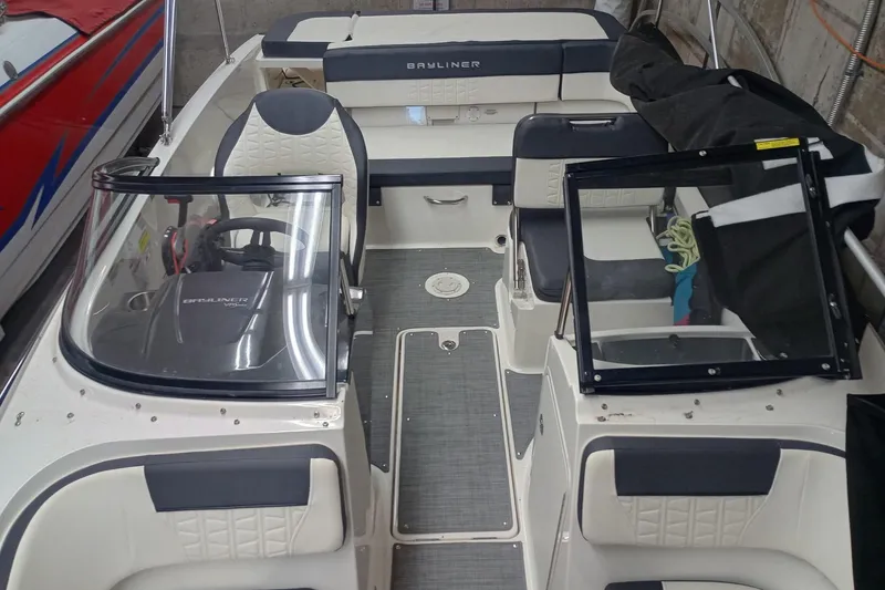 Slide: The Image of 2022 Bayliner VR5 Bowrider I/O interior with seating and steering wheel in a garage. - 29