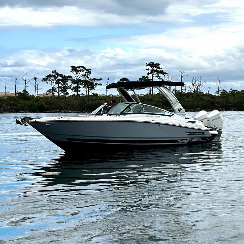 The Image of 2023 Monterey 305SS Super Sport boat cruising on a sunny day near a marina. - 0