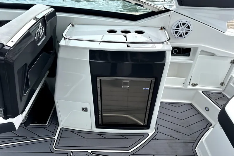 Slide: The Image of 2023 Monterey 305SS Super Sport boat interior with luxurious seating on a sunny day. - 10