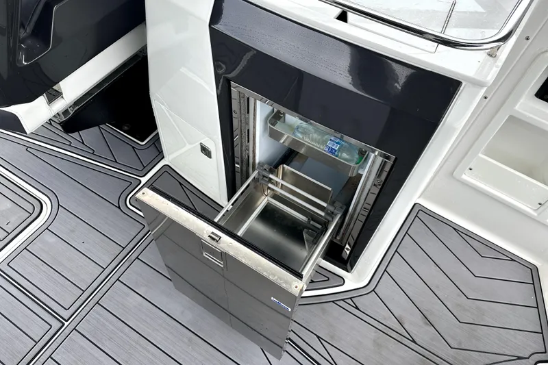 Slide: The Image of 2023 Monterey 305SS Super Sport boat with luxurious seating and dual outboard engines. - 12