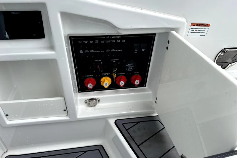 Slide: The Image of 2023 Monterey 305SS Super Sport boat interior with dual Mercury engines on a calm lake. - 13