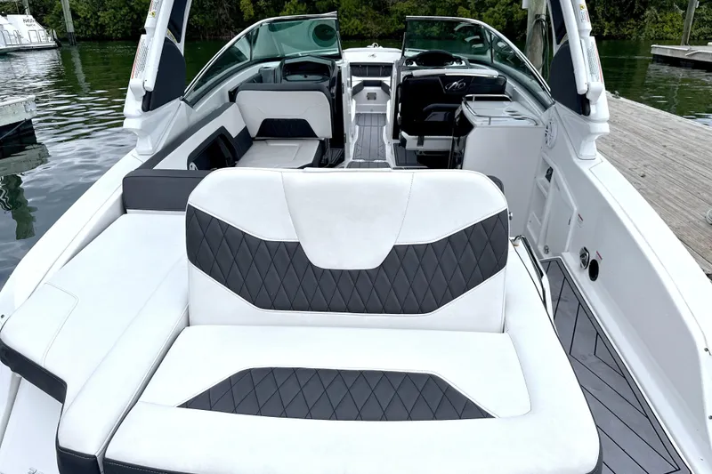 Slide: The Image of 2023 Monterey 305SS Super Sport boat interior with luxurious seating and scenic water view. - 15