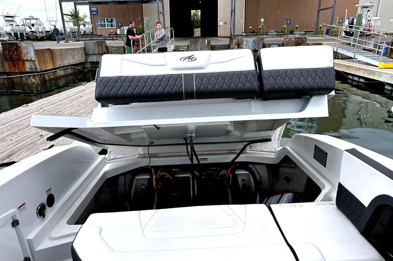 Slide: The Image of 2023 Monterey 305SS Super Sport boat interior with sleek dashboard and open seating area. - 27