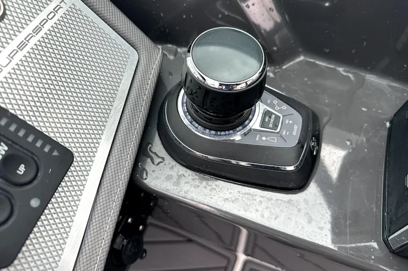 Slide: The Image of 2023 Monterey 305SS Super Sport boat interior with steering wheel and luxurious seating. - 28