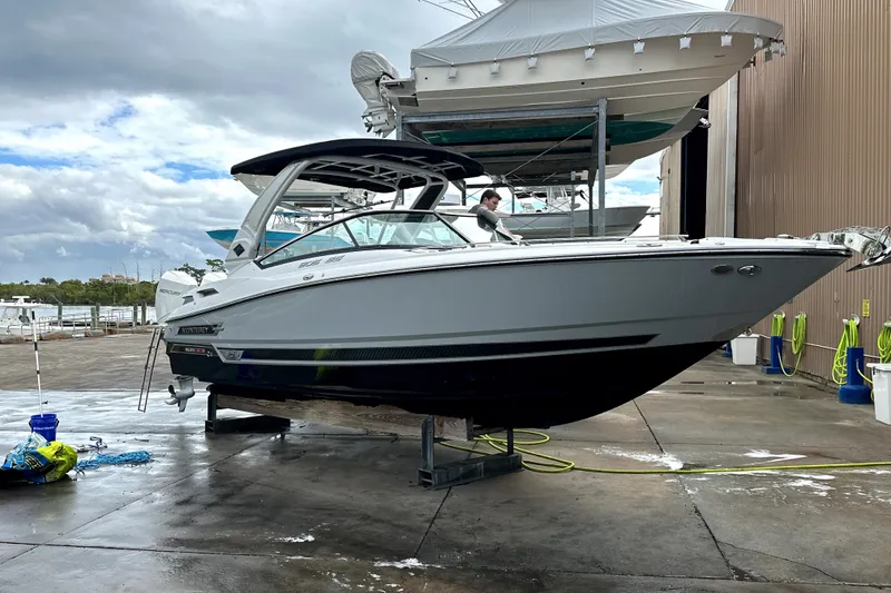 Slide: The Image of 2023 Monterey 305SS Super Sport boat cruising on a sunny day in a scenic marina. - 3