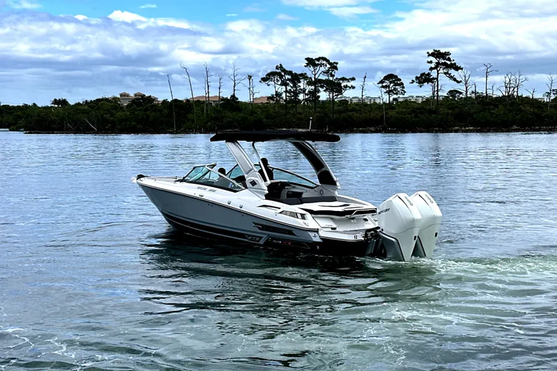 Slide: The Image of 2023 Monterey 305SS Super Sport boat interior with luxurious seating and scenic water view. - 31