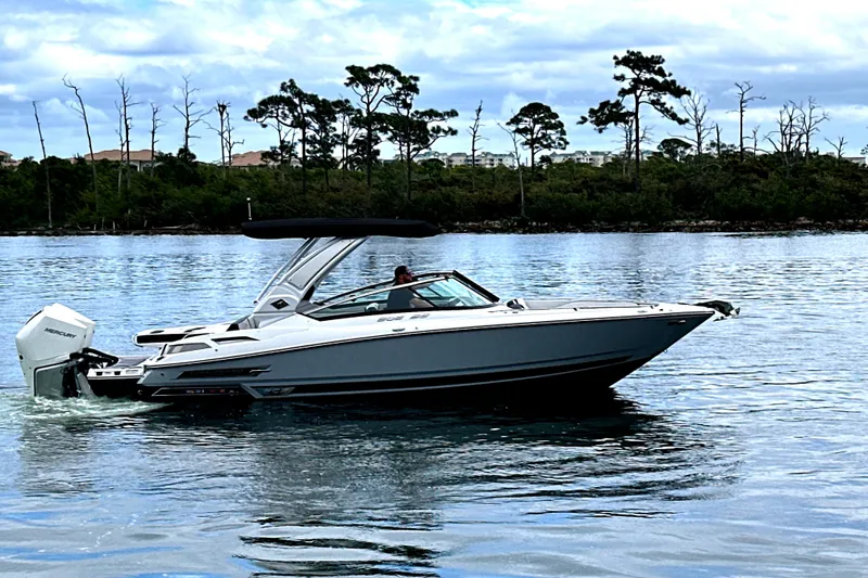 Slide: The Image of 2023 Monterey 305SS Super Sport boat interior with luxurious seating on a sunny day. - 32