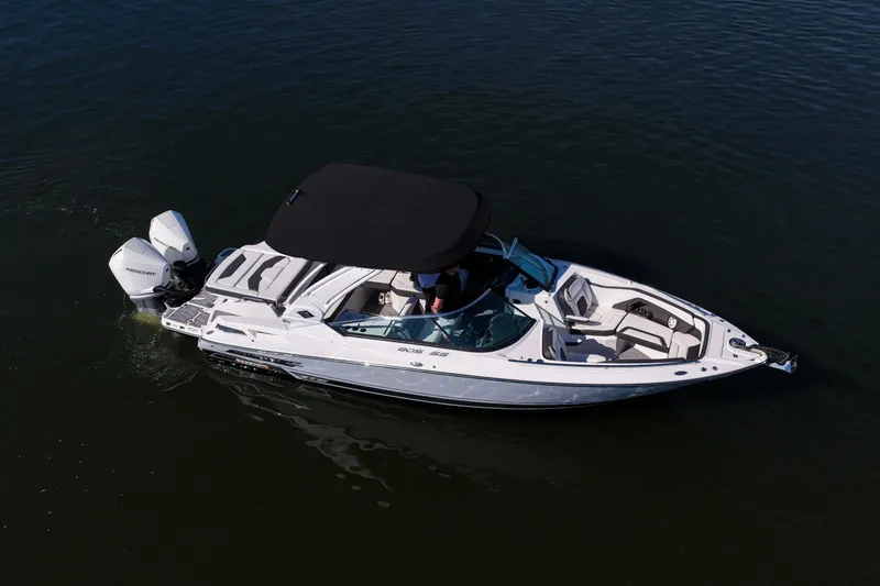 Slide: The Image of 2023 Monterey 305SS Super Sport boat on water, featuring sleek design and dual engines. - 38