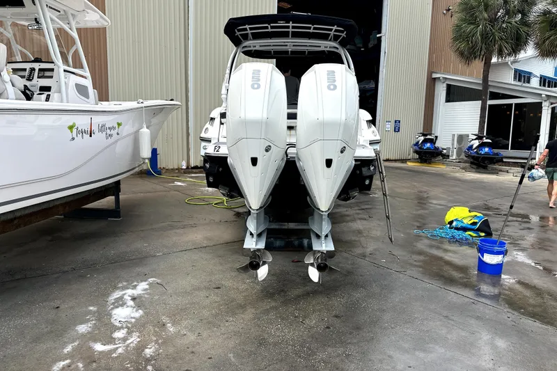 Slide: The Image of 2023 Monterey 305SS Super Sport boat with dual Mercury engines on a calm lake. - 4