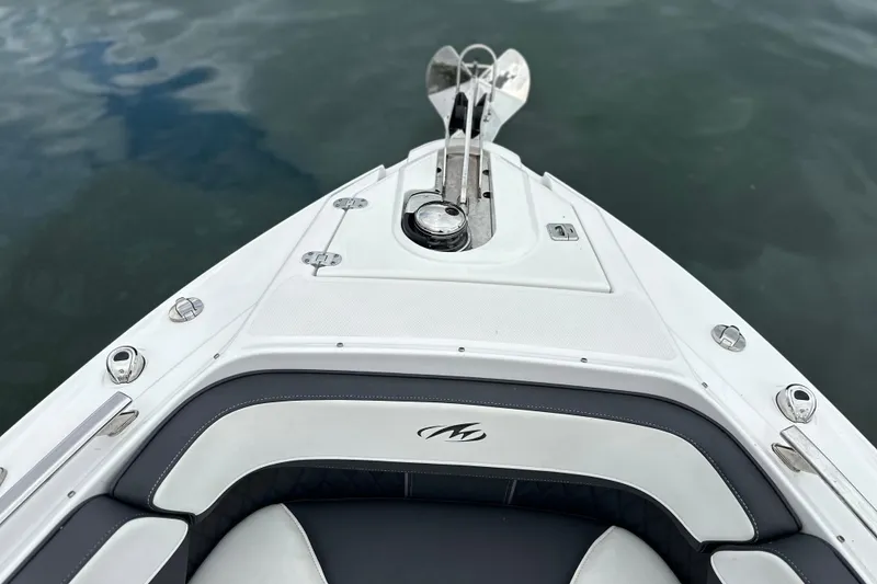 Slide: The Image of 2023 Monterey 305SS Super Sport with dual Mercury outboard engines on a calm lake. - 7