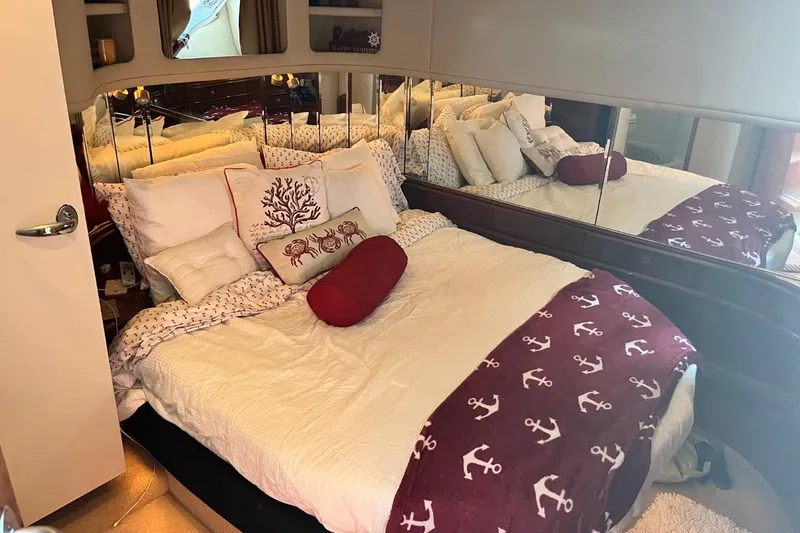 Slide: The Image of Cozy bedroom in 2003 Sea Ray 550 Sundancer yacht with nautical-themed decor. - 10