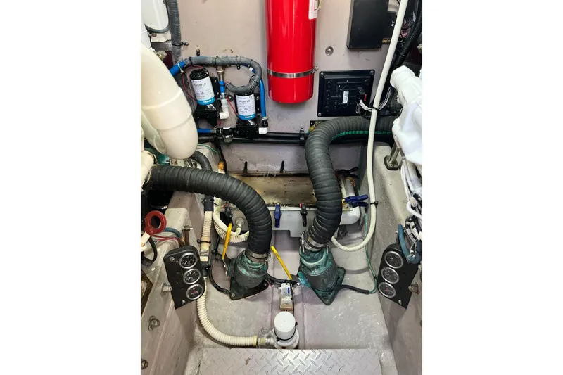 Slide: The Image of Engine room of 2003 Sea Ray 550 Sundancer with hoses and gauges. - 12