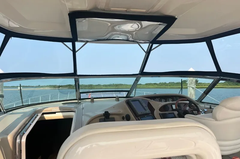Slide: The Image of Interior view of 2003 Sea Ray 550 Sundancer yacht cockpit with scenic water backdrop. - 3