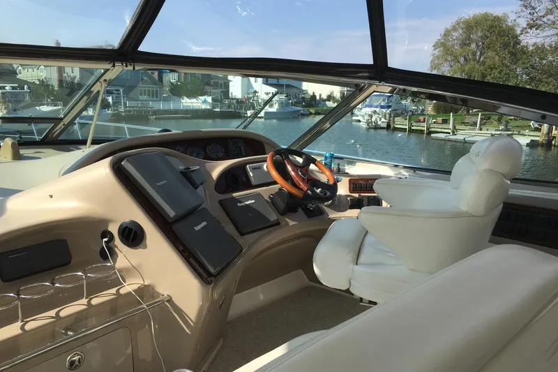 Slide: The Image of Luxurious 2003 Sea Ray 550 Sundancer yacht cockpit with plush seating and modern controls. - 4