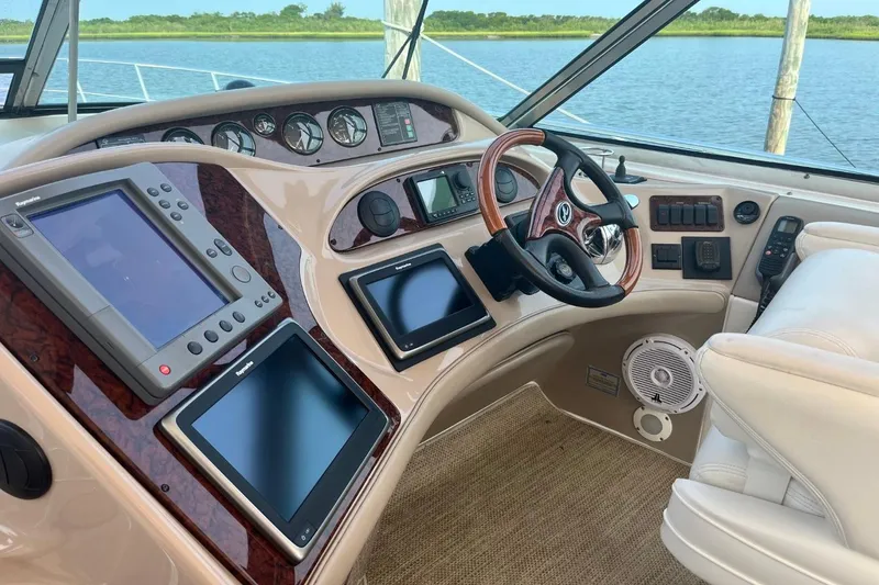 Slide: The Image of 2003 Sea Ray 550 Sundancer helm with advanced navigation systems and luxurious seating. - 5