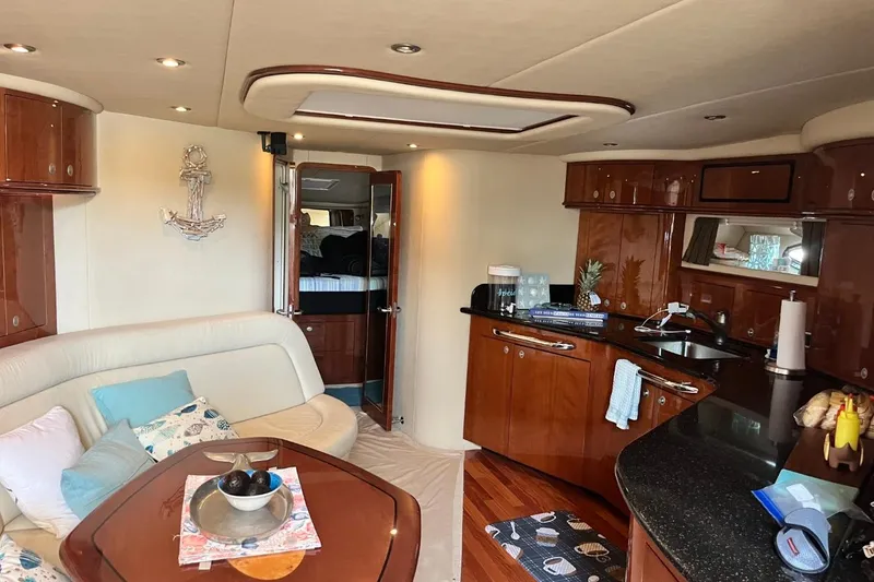 Slide: The Image of Luxurious interior of a 2003 Sea Ray 550 Sundancer yacht with elegant wood finishes. - 8