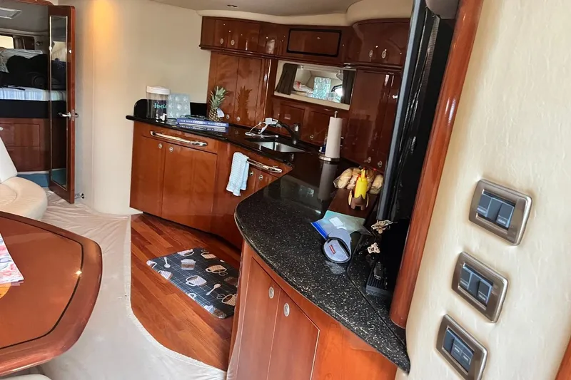 Slide: The Image of Luxurious 2003 Sea Ray 550 Sundancer yacht interior with elegant wood cabinetry and modern amenities. - 9