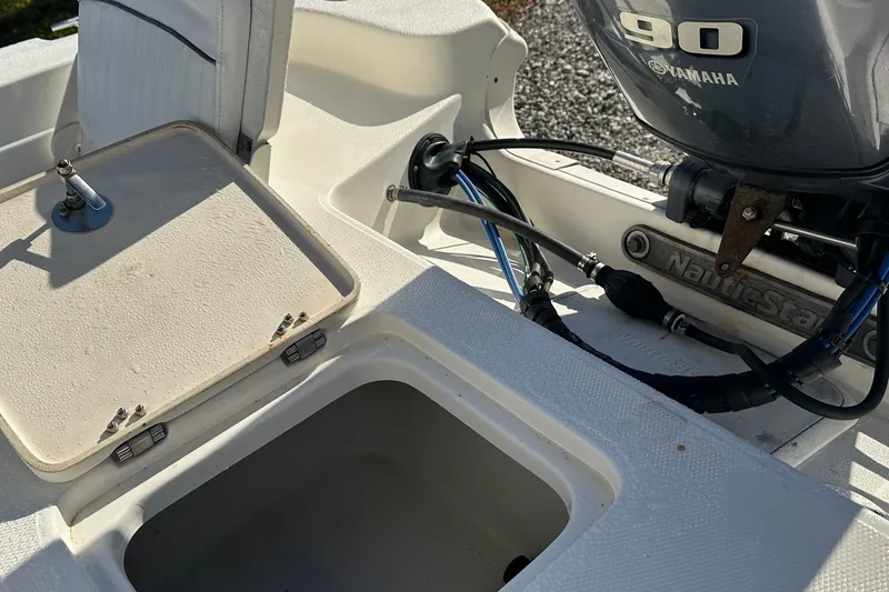 Slide: The Image of 2014 Nautistar 1810 CC boat with Yamaha 90 engine, open storage compartment. - 6