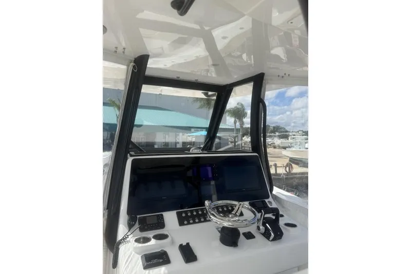 Slide: The Image of 2024 Front Runner 36 Center Console boat dashboard with modern controls and navigation screens. - 3