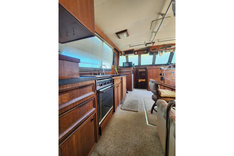 Slide: The Image of 1976 Hatterus 42 Long Range Cruiser interior with wood cabinetry and helm. - 11