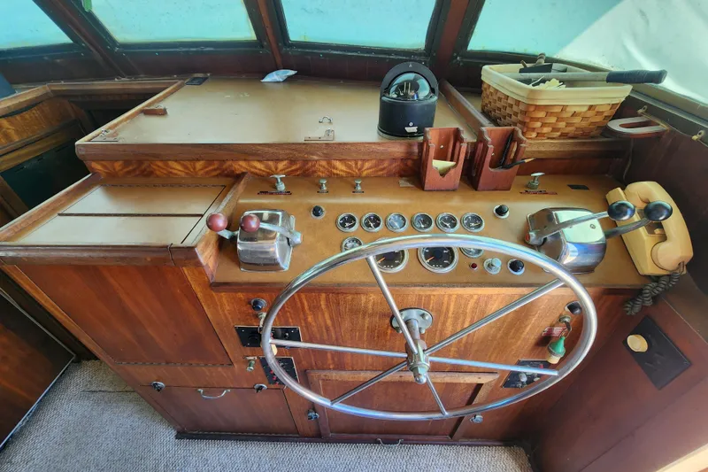 Slide: The Image of 1976 Hatterus 42 Long Range Cruiser helm with vintage controls and steering wheel. - 12