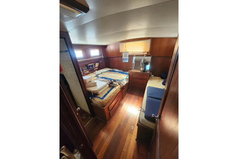 Slide: The Image of Interior of 1976 Hatterus 42 Long Range Cruiser with wooden furnishings and cozy cabin. - 13