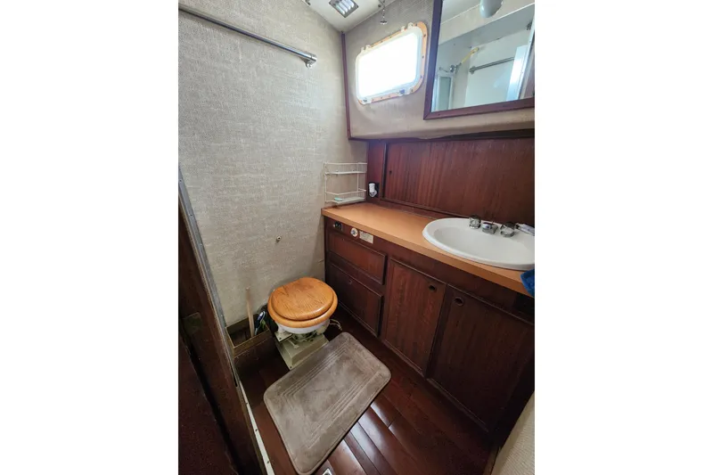 Slide: The Image of 1976 Hatterus 42 Long Range Cruiser bathroom with wooden cabinetry and compact design. - 15