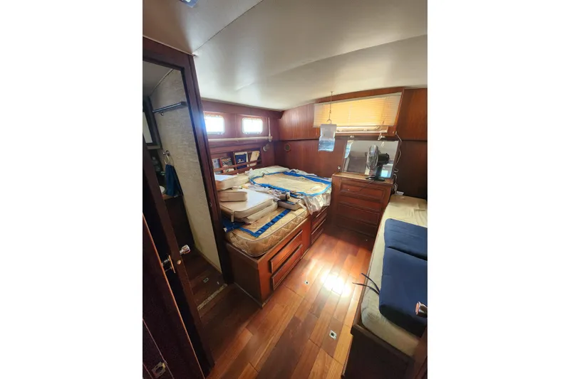 Slide: The Image of 1976 Hatterus 42 Long Range Cruiser cabin with wooden interior and cozy furnishings. - 16