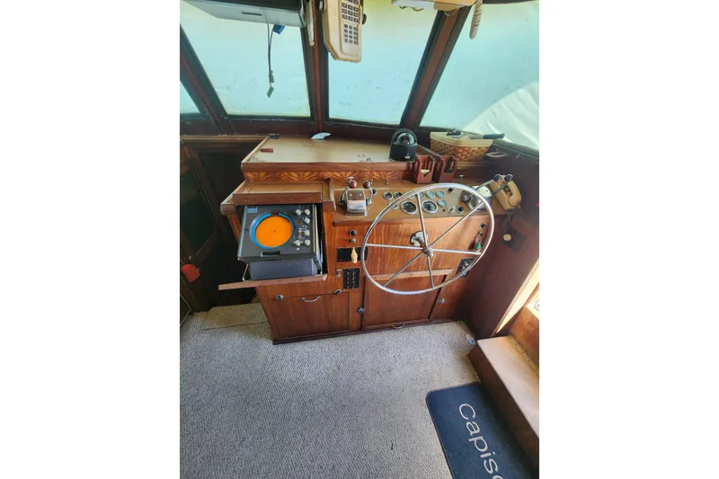 Slide: The Image of 1976 Hatterus 42 Long Range Cruiser helm with vintage controls and navigation equipment. - 17