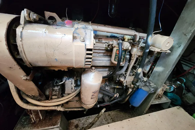 Slide: The Image of Engine of a 1976 Hatterus 42 Long Range Cruiser, showing detailed mechanical components. - 22