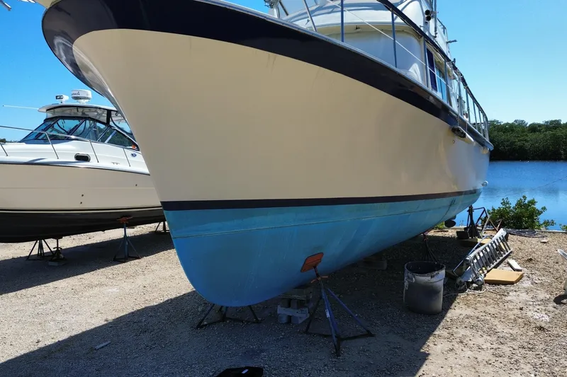 Slide: The Image of 1976 Hatterus 42 Long Range Cruiser on dry dock near water. - 6