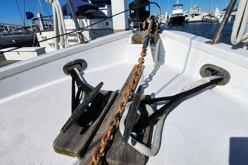 Slide: The Image of Bow of 1996 Tillotson-Pearson Motorsailer 32 with anchor chain and ropes in marina. - 19