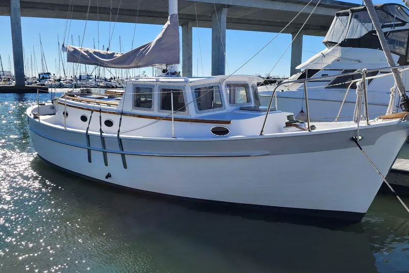 Slide: The Image of 1996 Tillotson-Pearson Motorsailer 32 docked in a sunny marina. - 2