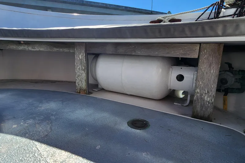 Slide: The Image of Propane tank storage on 1996 Tillotson-Pearson Motorsailer 32 deck, secured with wooden supports. - 24