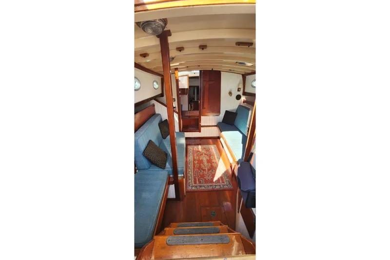 Slide: The Image of Interior of 1996 Tillotson-Pearson Motorsailer 32 with wooden finish and blue seating. - 27
