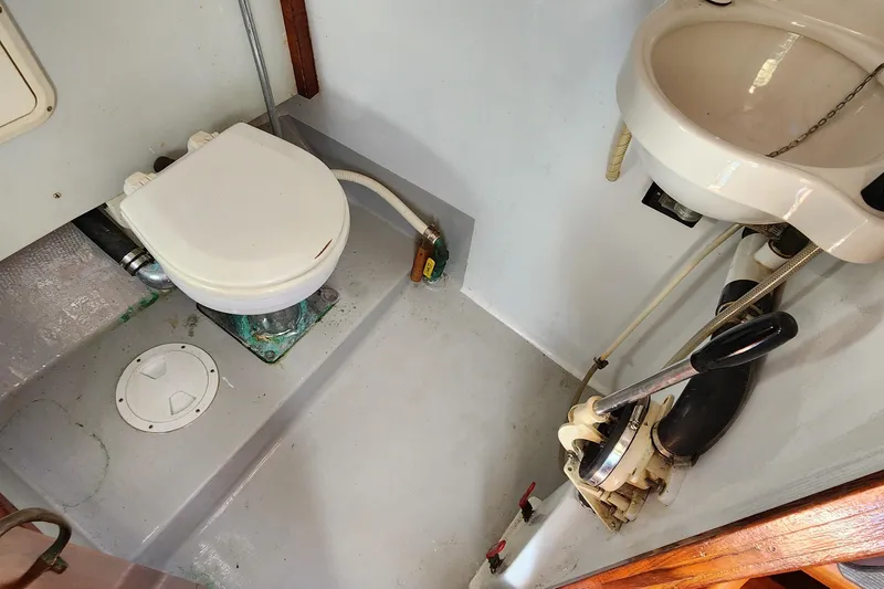 Slide: The Image of Bathroom of 1996 Tillotson-Pearson Motorsailer 32 with toilet and sink. - 32