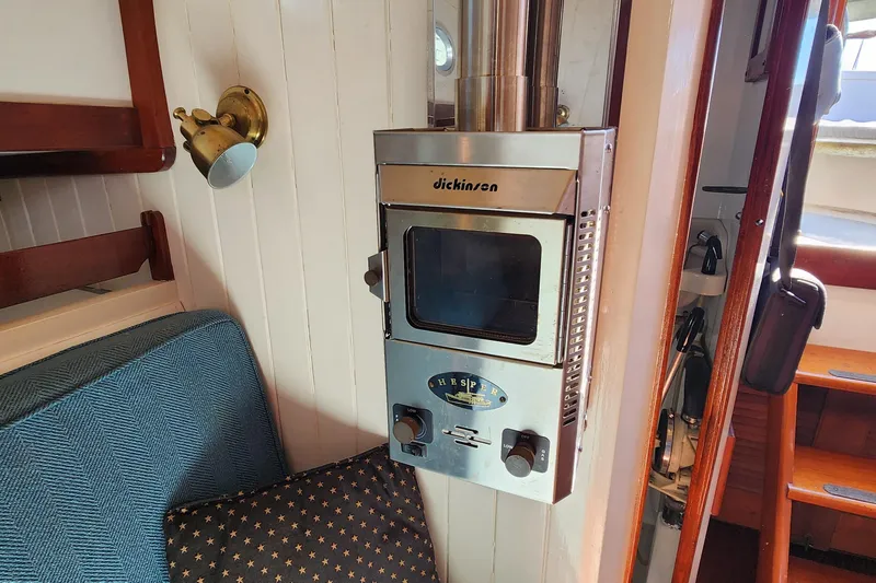 Slide: The Image of Cozy interior of 1996 Tillotson-Pearson Motorsailer 32 with Dickinson heater. - 33