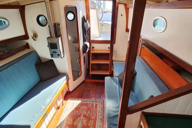 Slide: The Image of Interior of 1996 Tillotson-Pearson Motorsailer 32 with cozy seating and nautical decor. - 36