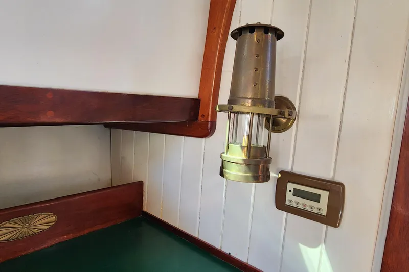 Slide: The Image of Interior of 1996 Tillotson-Pearson Motorsailer 32 with brass lamp and control panel. - 39