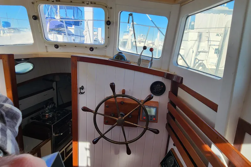 Slide: The Image of Interior view of 1996 Tillotson-Pearson Motorsailer 32, featuring helm and navigation equipment. - 47