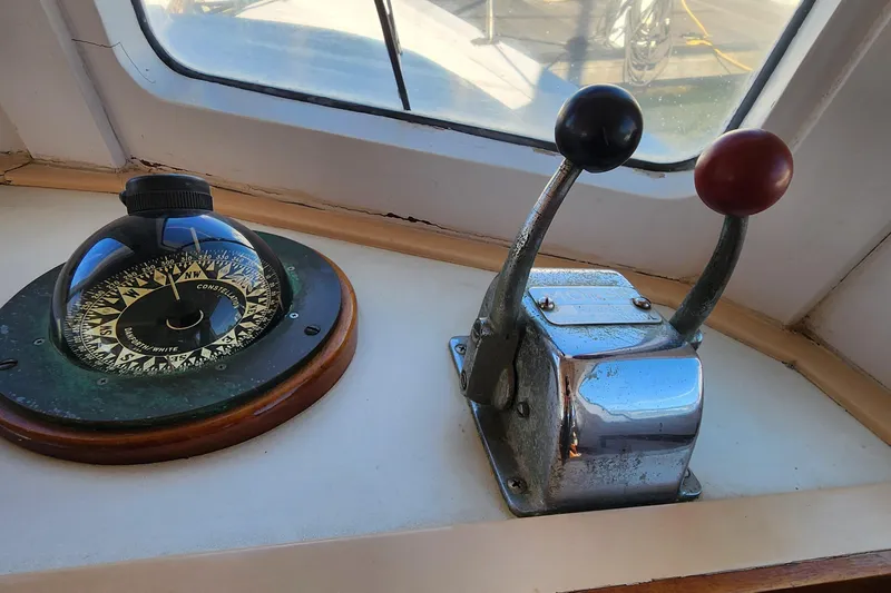 Slide: The Image of Compass and throttle controls on a 1996 Tillotson-Pearson Motorsailer 32. - 48