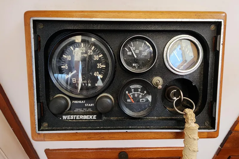 Slide: The Image of Control panel of a 1996 Tillotson-Pearson Motorsailer 32 with Westerbeke engine gauges. - 49