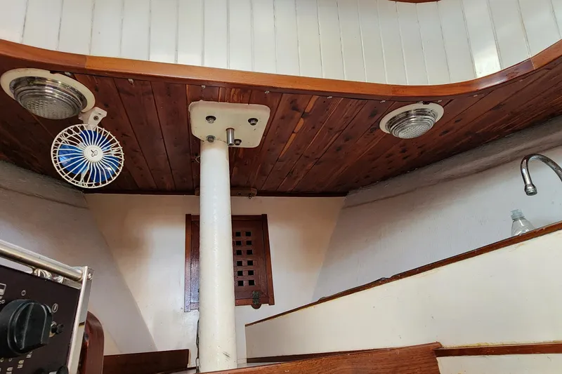 Slide: The Image of Interior of 1996 Tillotson-Pearson Motorsailer 32 with wooden ceiling and fan. - 59