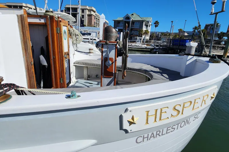 Slide: The Image of 1996 Tillotson-Pearson Motorsailer 32 docked, featuring wooden accents and "Hesper" nameplate. - 6