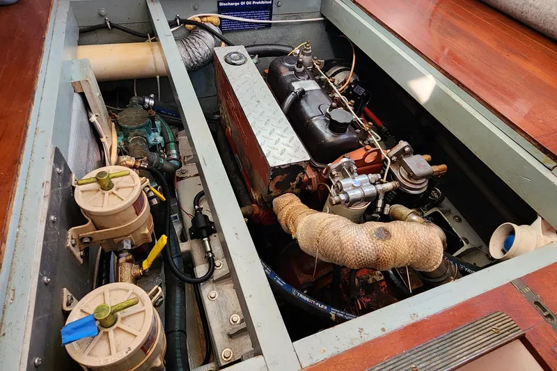 Slide: The Image of Engine compartment of a 1996 Tillotson-Pearson Motorsailer 32, showcasing mechanical components. - 62