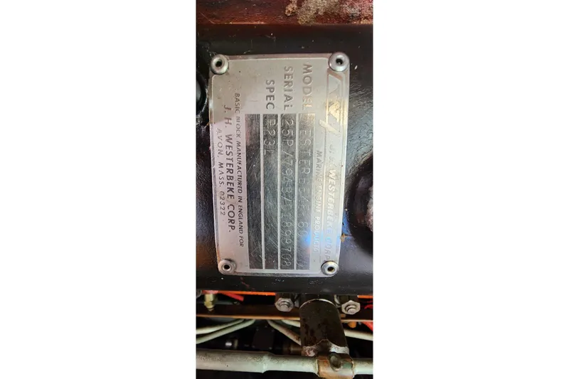 Slide: The Image of Engine plate of a 1996 Tillotson-Pearson Motorsailer 32, featuring model and serial details. - 63