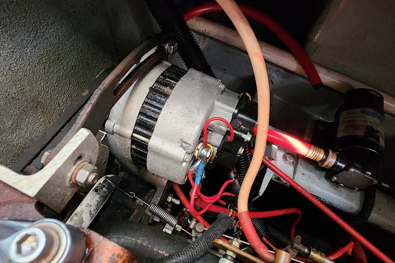 Slide: The Image of Engine compartment of a 1996 Tillotson-Pearson Motorsailer 32 with visible wiring and components. - 64