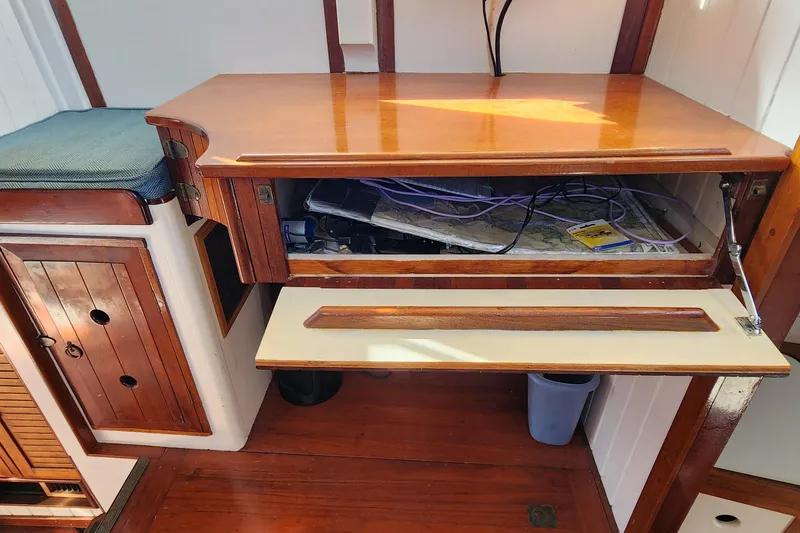 Slide: The Image of Interior of 1996 Tillotson-Pearson Motorsailer 32 with wooden cabinetry and storage space. - 67