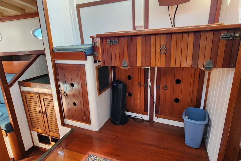Slide: The Image of Interior of 1996 Tillotson-Pearson Motorsailer 32, featuring wooden cabinetry and seating. - 68